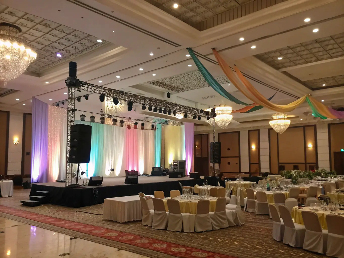 A wide-angle shot of the main hall, showcasing its high ceilings, flexible seating arrangements, and professional stage lighting, suitable for a theatrical performance.