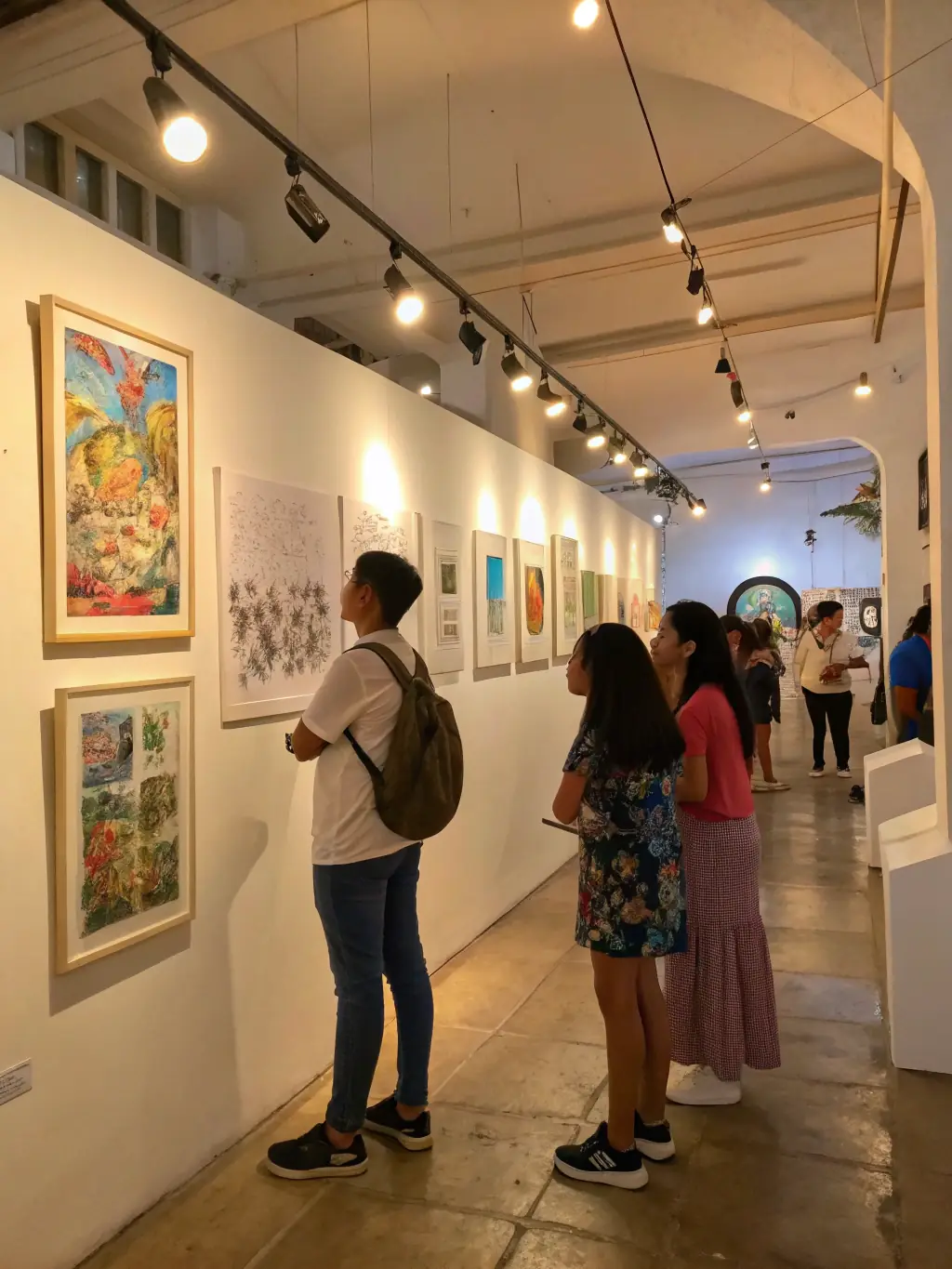 A high-quality image of a local art exhibition held at the venue, featuring various paintings and sculptures, with attendees admiring the artwork, emphasizing the venue's support for local artists.